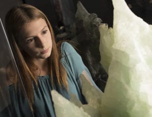 young woman looking at minerals