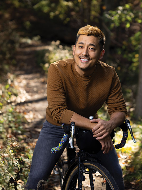 person posing for a photo with a bicycle