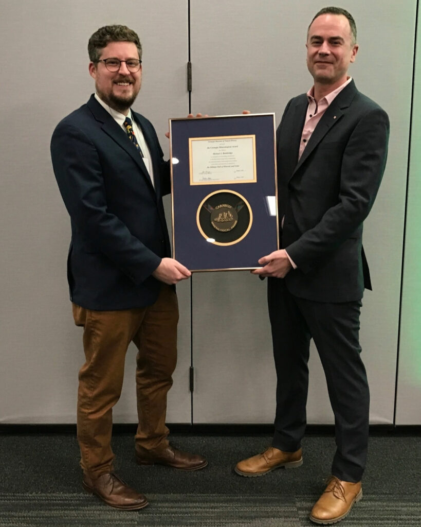 Travis Olds and Michael Bainbridge holding the Carnegie Mineralogical Award.
