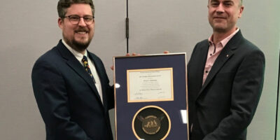 Travis Olds and Michael Bainbridge holding the Carnegie Mineralogical Award