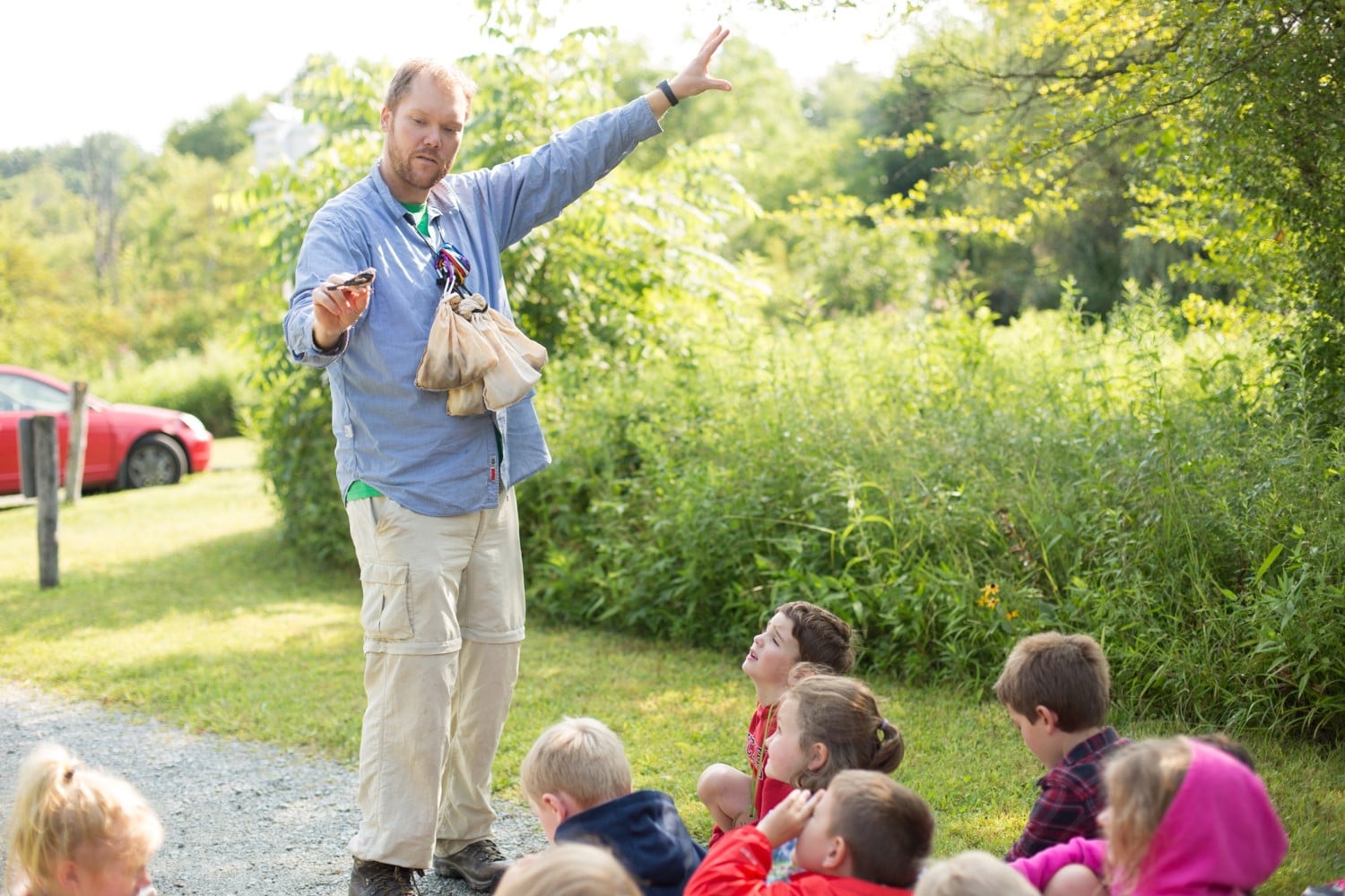 Luke DeGroote showing children a bird