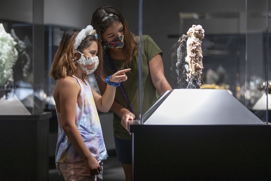 girls looking at mineral