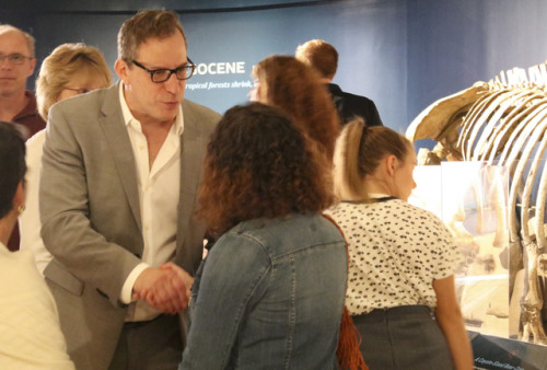 Museum director shaking hands with visitors